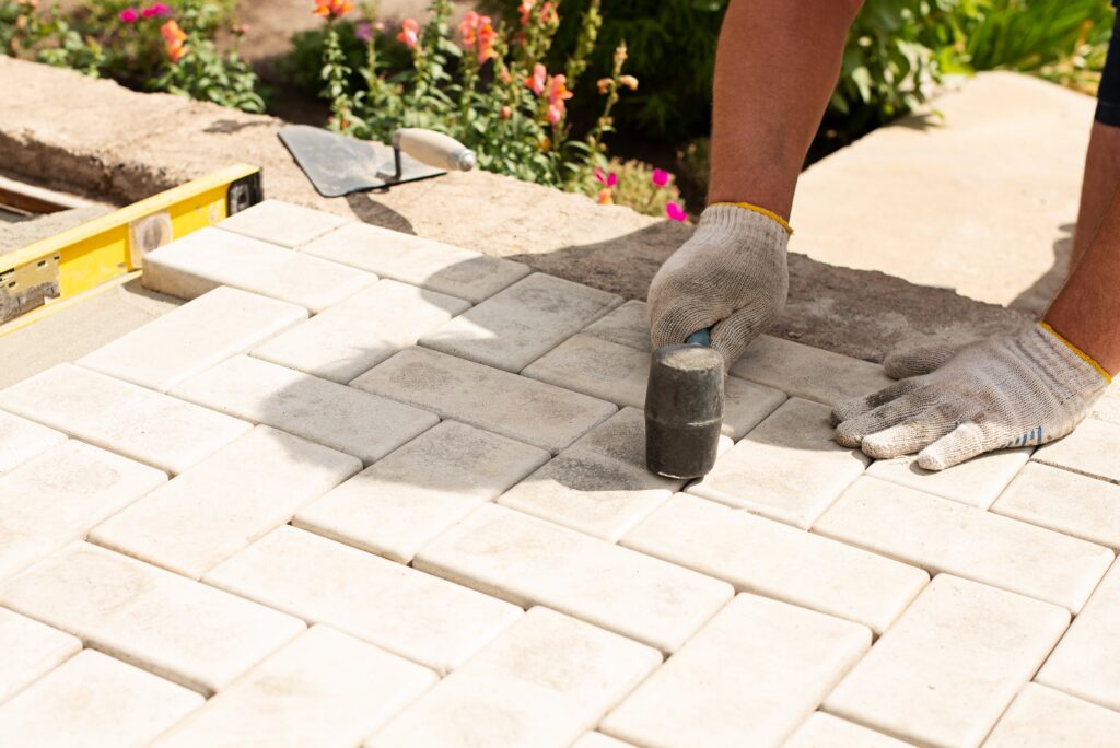 laying-gray-concrete-paving-slabs-house-courtyard-sand-foundation-base-min
